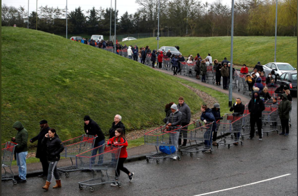 People queue outside of a Costco store in Watford, Britain, amid the spread of Covid-19 as UK considered a strategy of herd immunity, March 19. — Reuters