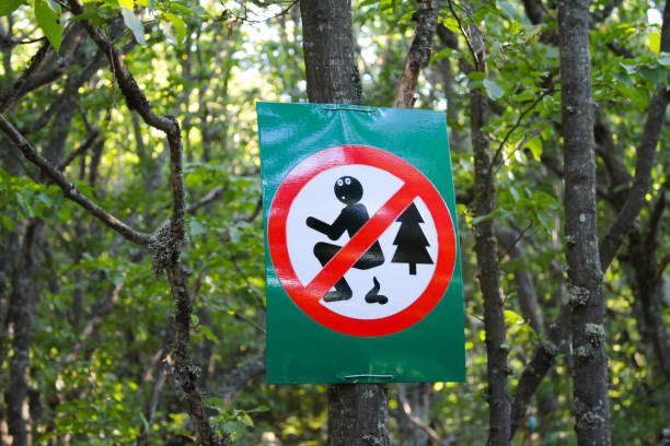 a-sign-on-a-tree-in-a-forest-or-park-prohibits-people-from-pooping-in-nature.jpg
